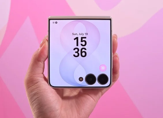 Samsung Galaxy Z Flip8 folded in a hand, showing the time on its cover screen